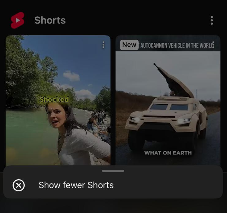 YouTube Shorts shelf on the home feed with the three-dot menu open and the Show fewer Shorts option visible.